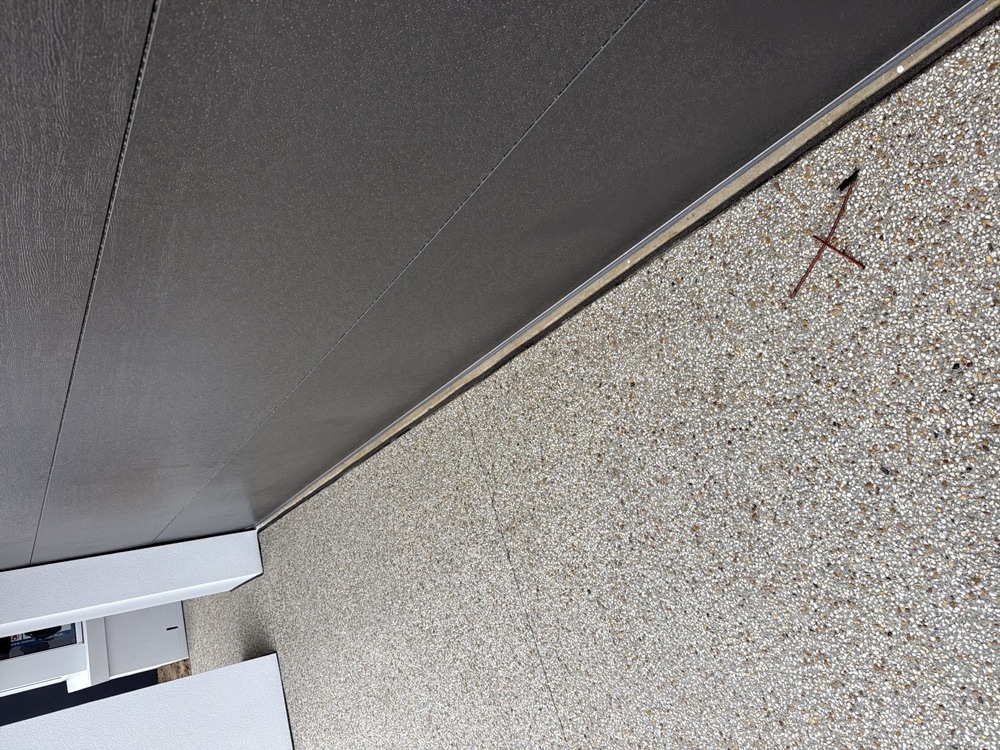 Slab to driveway joint not sealed, letting debris and water under the slab, found during a pre-handover inspection in Clyde