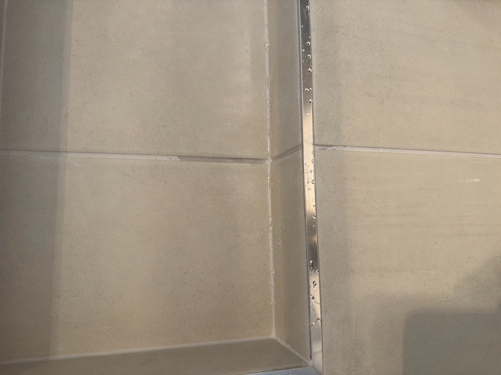 Shower grout joints unsealed, recommended before the wet area is used, found during a pre-handover inspection in Clyde