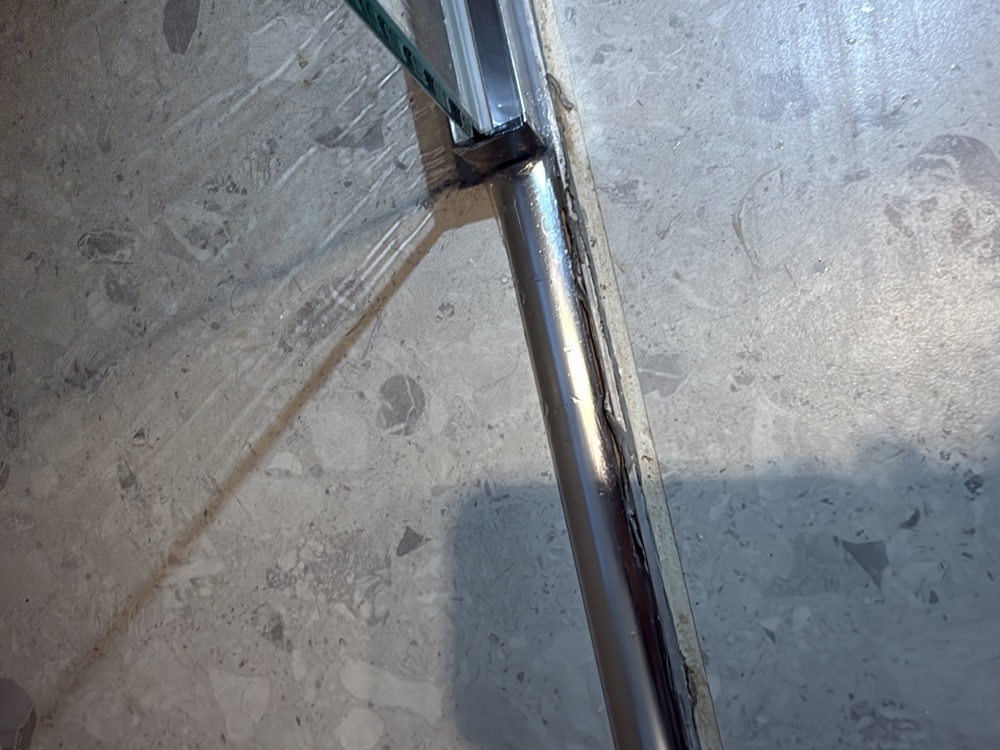 Finish around the shower water stop angle inconsistent, risking water tracking out, found during a pre-handover inspection in Clyde